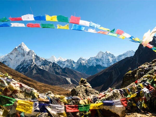 Vibrant prayer flags with the backdrop of Mount Everest and the surrounding peaks