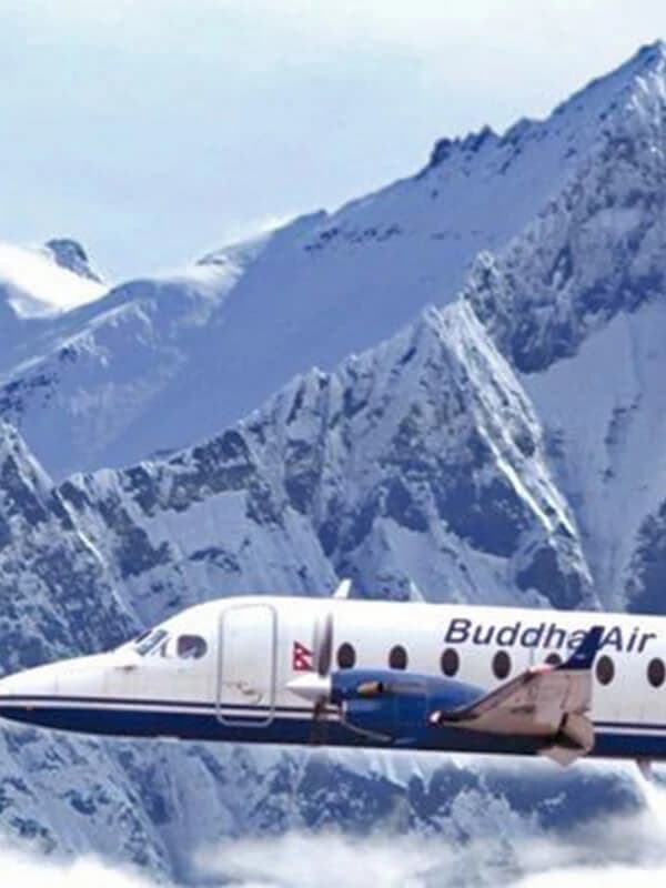 A scenic mountain flight in Nepal with an airplane flying close to the Himalayas, offering a clear view of snow-capped peaks.