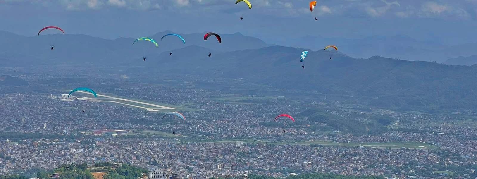 Paragliding in Pokhara with stunning mountain views.